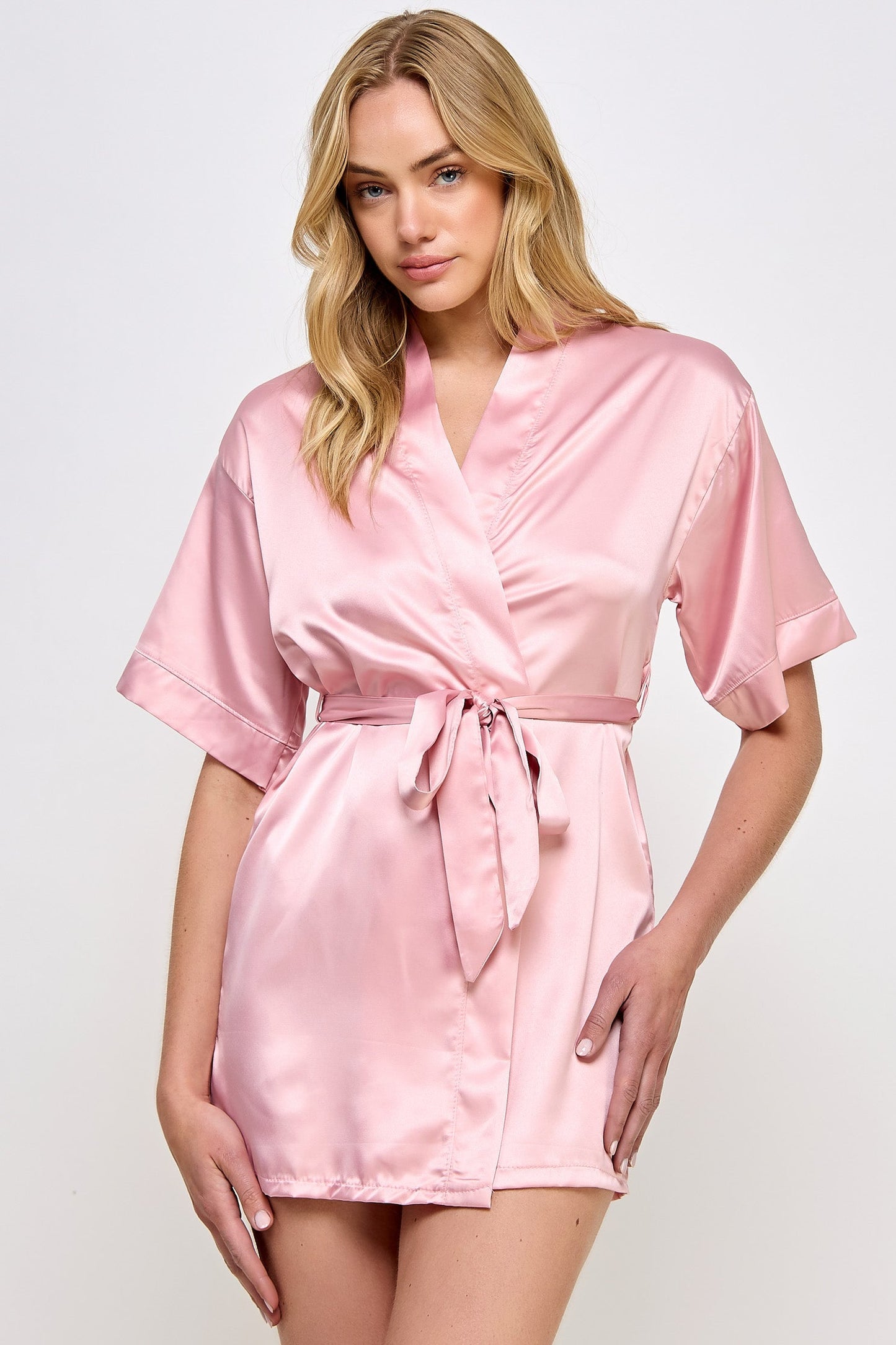 The Satin Lightweight Robe is the epitome of elegance and comfort, designed for those who appreciate the finer things in life. Crafted from premium satin, this robe boasts a sleek and smooth texture that feels luxurious against the skin. Its lightweight design ensures breathability and ease of movement, making it perfect for lounging in style or preparing for a day or evening out. Short length Open front Matching front tie satin belt