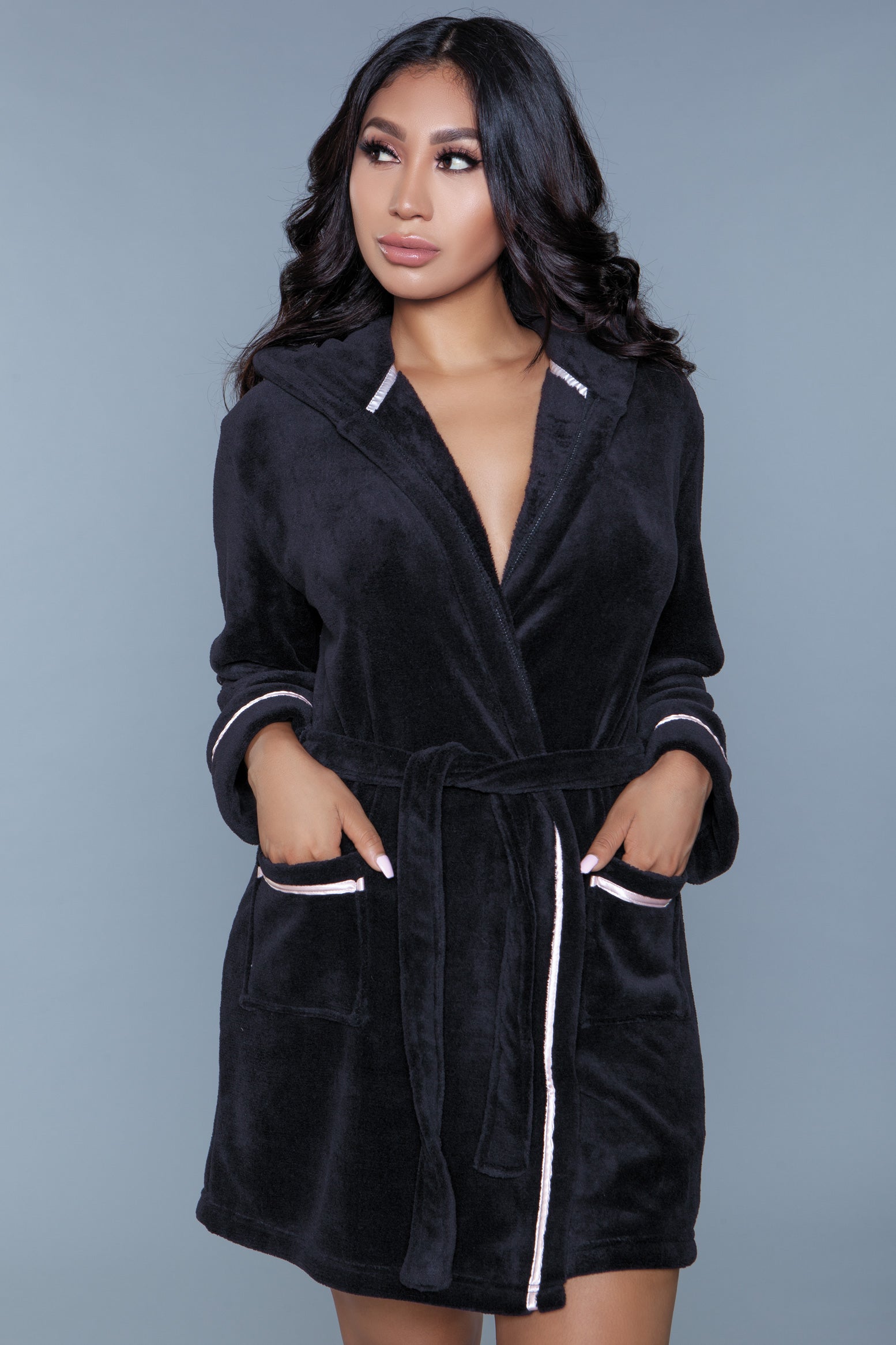 The Alyssa Robe is the ultimate in luxurious loungewear, featuring a plush, soft fabric that wraps you in warmth and comfort. Designed with a cozy hood for extra warmth, this robe is perfect for those chillier mornings or relaxing evenings at home. It's elegantly finished with satin decorative piping, adding a touch of refinement to the cozy design. Open Front tie belt Long sleeves Front patch pockets