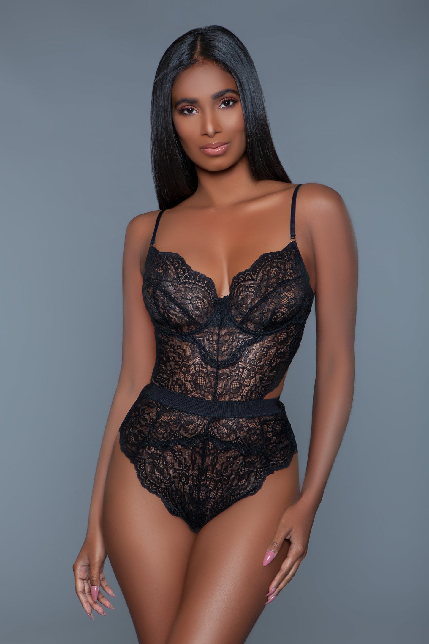 Indulge in elegance with this stunning lace bodysuit lingerie. Featuring a delicate scalloped hem for a touch of sophistication, a back keyhole cut-out detail for added allure, and a secure hook-and-eye closure for a perfect fit. This timeless piece is crafted from soft, stretchy lace that enhances your natural curves, making it ideal for special occasions or a romantic night in. Allover lace design Scalloped trim Modern cut-out design Unlined Underwire Back hook and eye closure Adjustable spaghetti straps