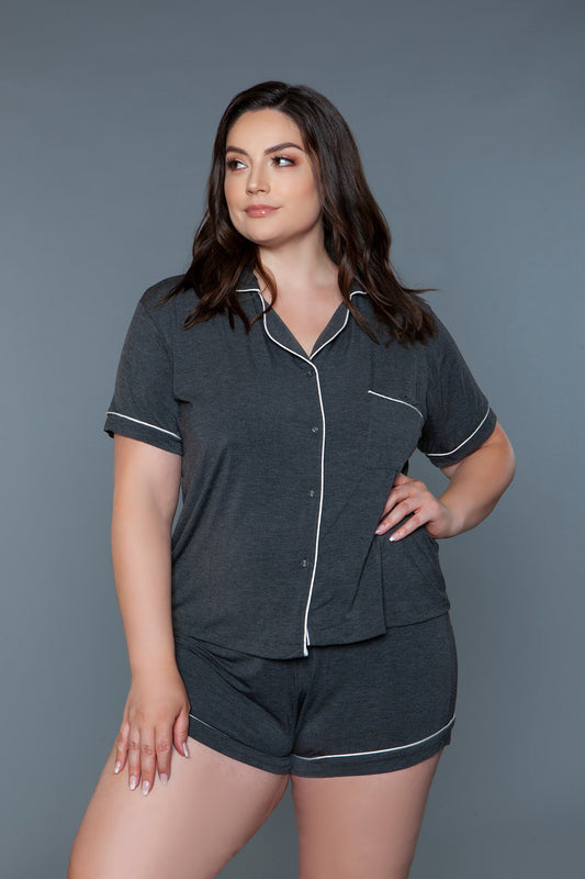 The Riley Pajama Set offers a classic and comfortable look, crafted from soft fabric for a cozy feel. This two-piece set includes a collared, short-sleeve shirt with a button-down front, a chic chest pocket, and refined piping detail along the edges for a touch of elegance. Paired with matching shorts featuring an elastic waist, this set is perfect for lounging or a restful night's sleep, combining style with ease. Notched collar Short sleeves Button-down closure Pocket on the chest Elastic waist Contrast 