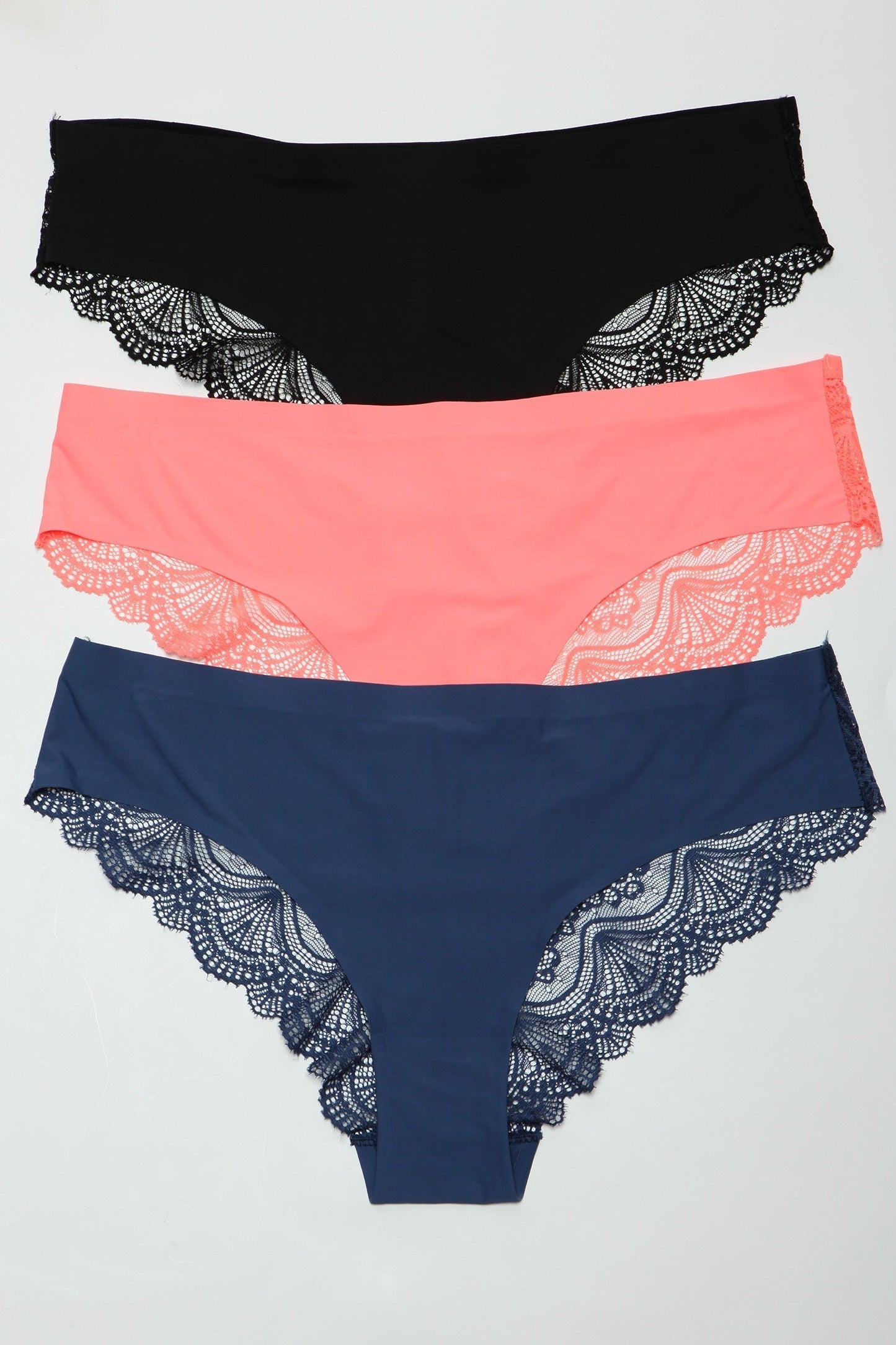 Elevate your lingerie collection with our seamless laser-cut front cheeky Arden Panty Pack, featuring a luxurious back-scalloped floral lace design. These panties combine elegance and comfort with their seamless construction, offering a smooth fit under any outfit. Midrise Front seamless laser cut design Back floral lace Scalloped back design Pack of black, navy blue, and coral colors.