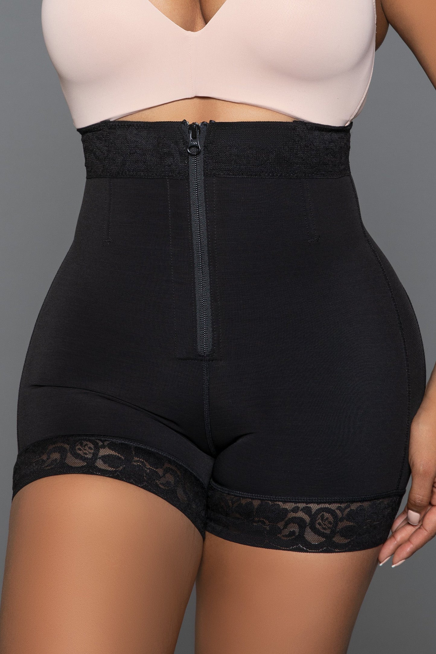 Achieve your desired silhouette with our Hug Me Close Bodyshaper Shorts. Featuring a convenient front zipper, these shorts provide easy wear and a secure fit. The tummy control design ensures a smooth and toned midsection, while the butt lifting feature enhances your natural curves for a flattering look. The lace hem adds a touch of elegance and femininity, making these shorts as stylish as they are functional. Front hook and eye and zipper closure Tummy control technology But lifting design Stretchy lace 