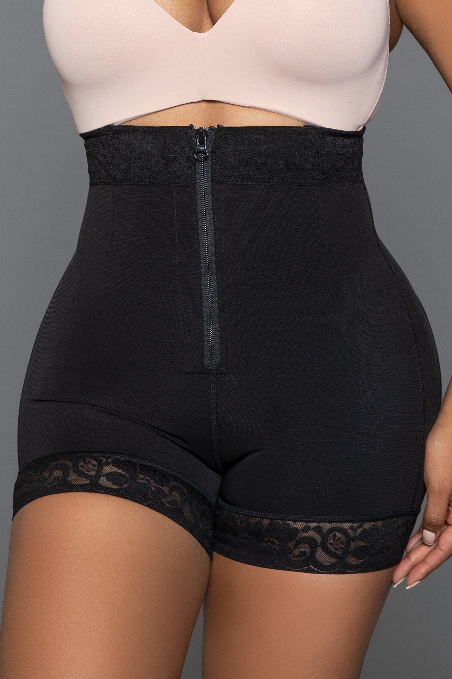 Achieve your desired silhouette with our Hug Me Close Bodyshaper Shorts. Featuring a convenient front zipper, these shorts provide easy wear and a secure fit. The tummy control design ensures a smooth and toned midsection, while the butt lifting feature enhances your natural curves for a flattering look. The lace hem adds a touch of elegance and femininity, making these shorts as stylish as they are functional. Front hook and eye and zipper closure Tummy control technology But lifting design Stretchy lace 