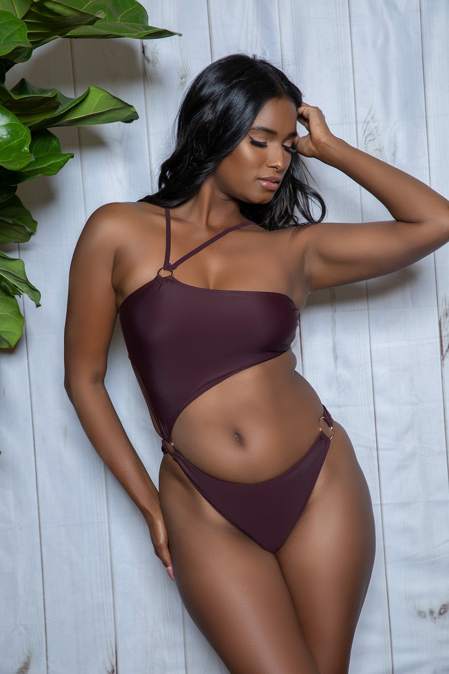 Introducing the Sofia Strappy One-Shoulder Cut-Out One-Piece, a daringly chic addition to any swimwear collection. This swimsuit embodies a blend of sophistication and edgy flair. With its bold silhouette and captivating details, this swimsuit is perfect for beach days or as a standout piece at poolside gatherings. Padded bandeau top Adjustable one-shoulder straps Cut out waist Metallic ring detail on the bottom High-cut medium coverage bottom Hand wash in cold water, dry in shade. Do not bleach/iron/dry c