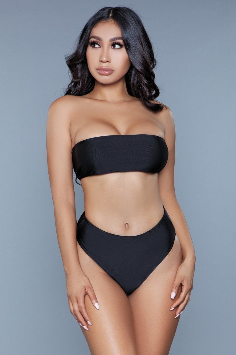 Embrace the warmth of the sun and the freedom of the sea with this elegantly designed swimsuit set, perfect for those who seek a blend of style and comfort. The Serenity features a chic strapless top, ensuring an even tan while offering a sophisticated silhouette that flatters the shoulders and neckline. Bandeau strapless top High-rise bottom High-cut bikini bottom Hand-wash cold separately, line dry. Do not twist or wring. Be Wicked Swimwear Polybag Packaging 82% Nylon 18% Spandex Lining: 95% Polyester 5%
