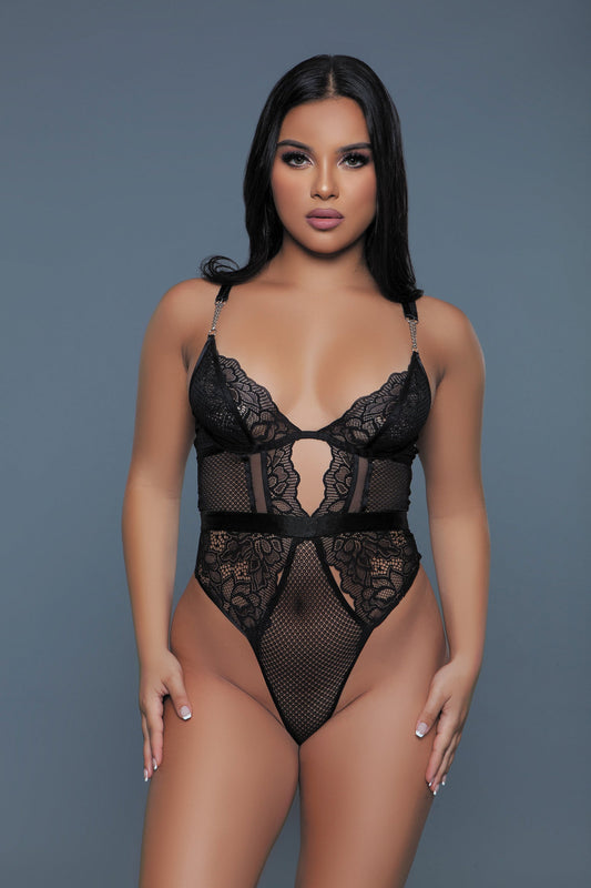 This stunning Camille lingerie bodysuit combines elegance with an edge, featuring delicate lace fabric with striking mesh panel contrasts for a textured, alluring look. The bodysuit is designed with chain details on the straps, adding a modern and daring touch. An open keyhole back elevates the piece with a hint of sensuality, while the soft, form-fitting material ensures comfort and a flattering silhouette. Ideal for making a statement, this bodysuit is perfect for those looking to bring a mix of sensual 