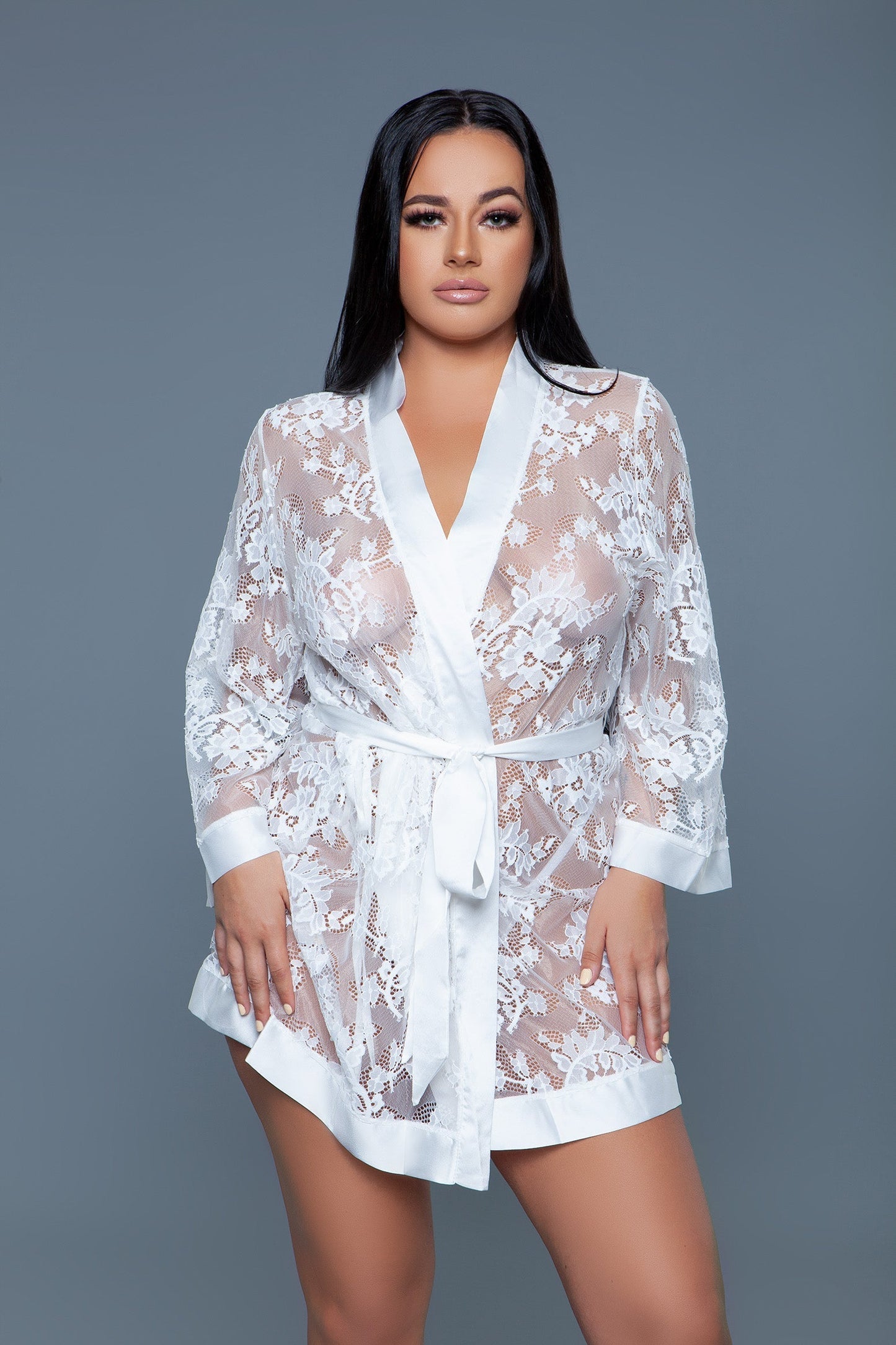 The Delia Robe with satin trim is a beautifully crafted piece that epitomizes elegance and femininity. This exquisite robe features a floral lace body that offers a peek of what's beneath, finished with smooth satin trim along the edges, including the cuffs, front opening, and hemline providing a perfect blend of allure and sophistication. Open front 3/4 Sleeves Matching front tie satin belt Thong not included