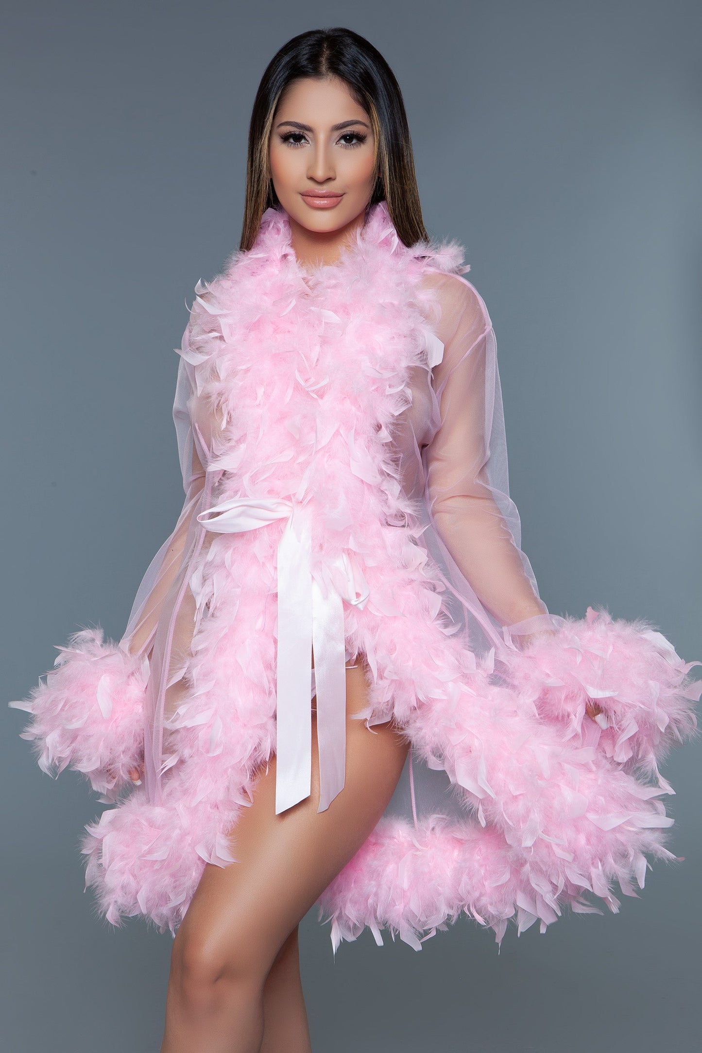 Lux short chiffon robe with feather boa trim is a playful yet elegant garment that combines the airy lightness of chiffon with the whimsical allure of a feather boa trim. This robe is designed for those who love to add a touch of glamour and fun to their loungewear. Sheer Feather trim Long sleeves Front tie satin ribbons Thong not included. Be Wicked polybag with Be Wicked hand tag and UPC stickers.