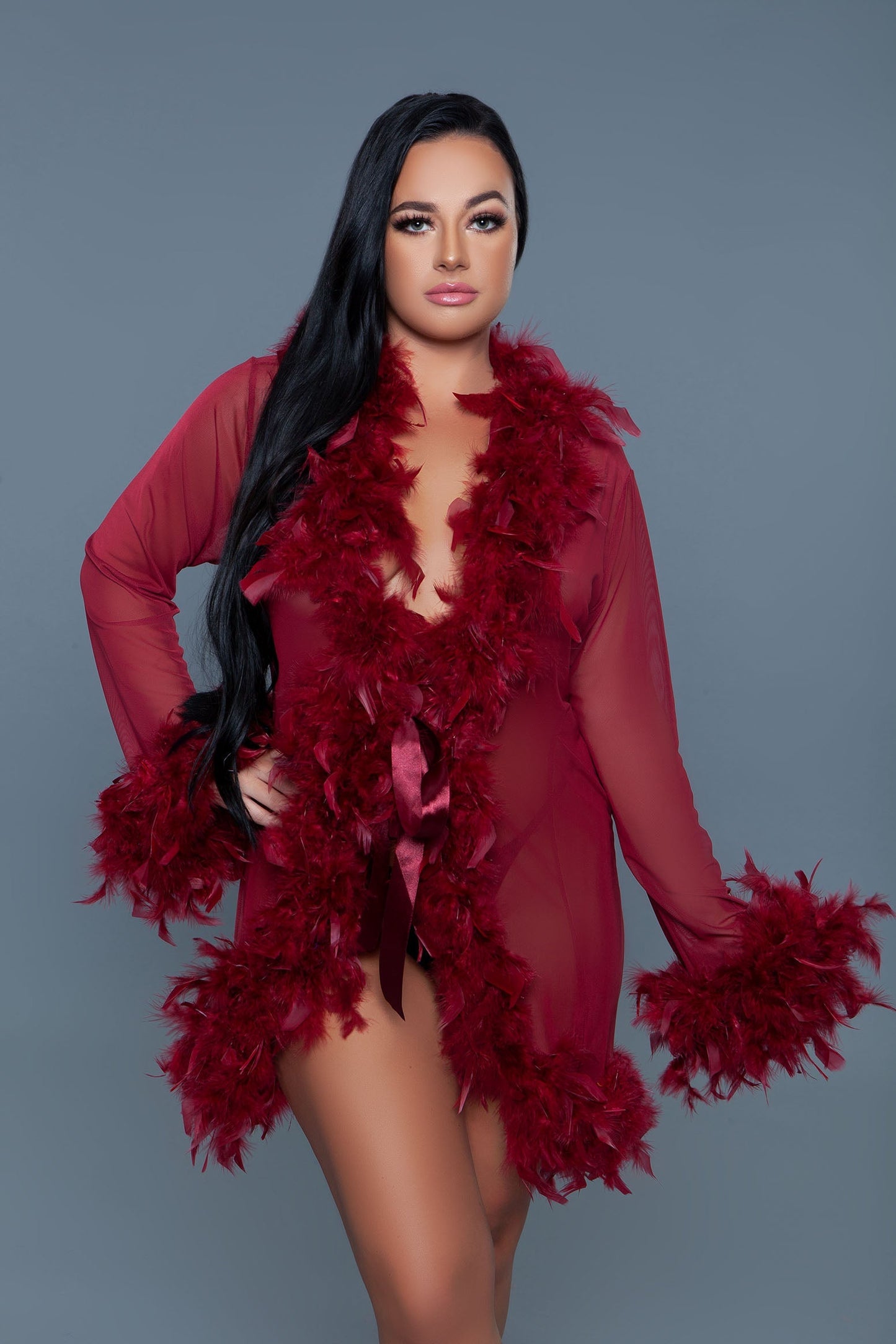 Lux short chiffon robe with feather boa trim is a playful yet elegant garment that combines the airy lightness of chiffon with the whimsical allure of a feather boa trim. This robe is designed for those who love to add a touch of glamour and fun to their loungewear. Sheer Feather trim Long sleeves Front tie satin ribbons Thong not included. Be Wicked polybag with Be Wicked hand tag and UPC stickers.