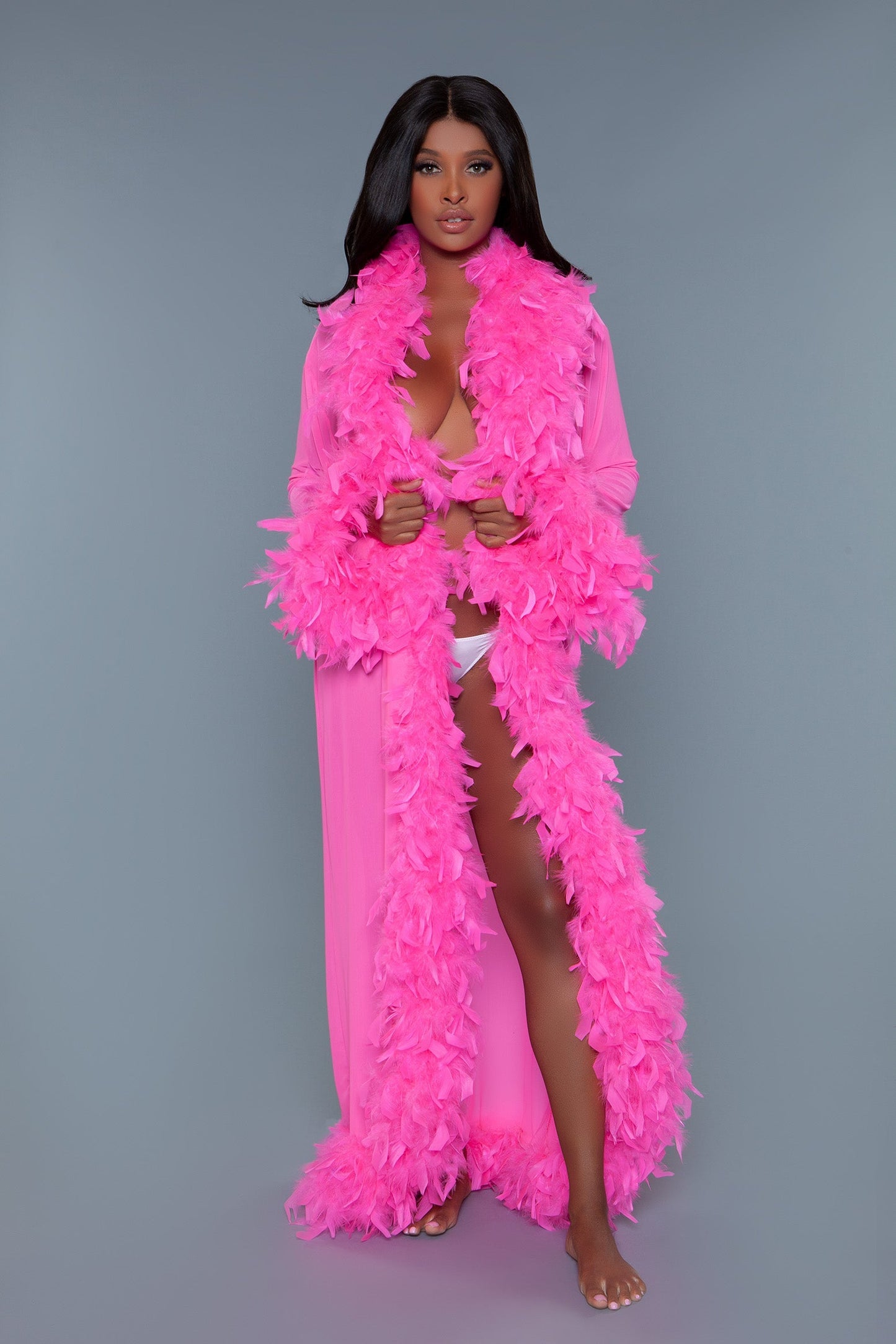 Long Glamour chiffon robe with feather boa trim is a playful yet elegant garment that combines the airy lightness of chiffon with the whimsical allure of a feather boa trim. This robe is designed for those who love to add a touch of glamour and fun to their loungewear. Sheer Feather trim Long sleeves Front tie satin ribbons Thong not included. Be Wicked polybag with Be Wicked hand tag and UPC stickers.