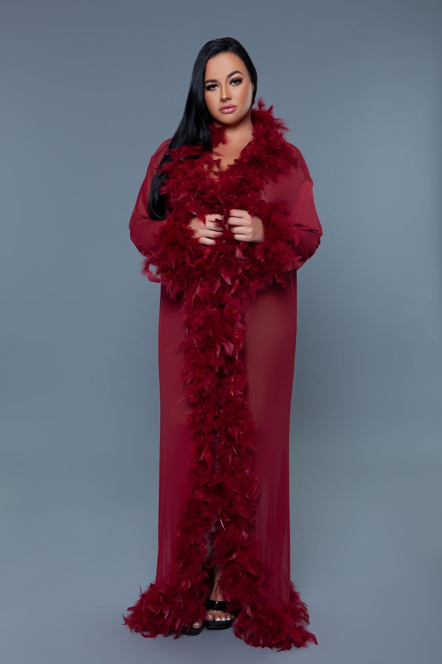 Long Glamour chiffon robe with feather boa trim is a playful yet elegant garment that combines the airy lightness of chiffon with the whimsical allure of a feather boa trim. This robe is designed for those who love to add a touch of glamour and fun to their loungewear. Sheer Feather trim Long sleeves Front tie satin ribbons Thong not included. Be Wicked polybag with Be Wicked hand tag and UPC stickers.