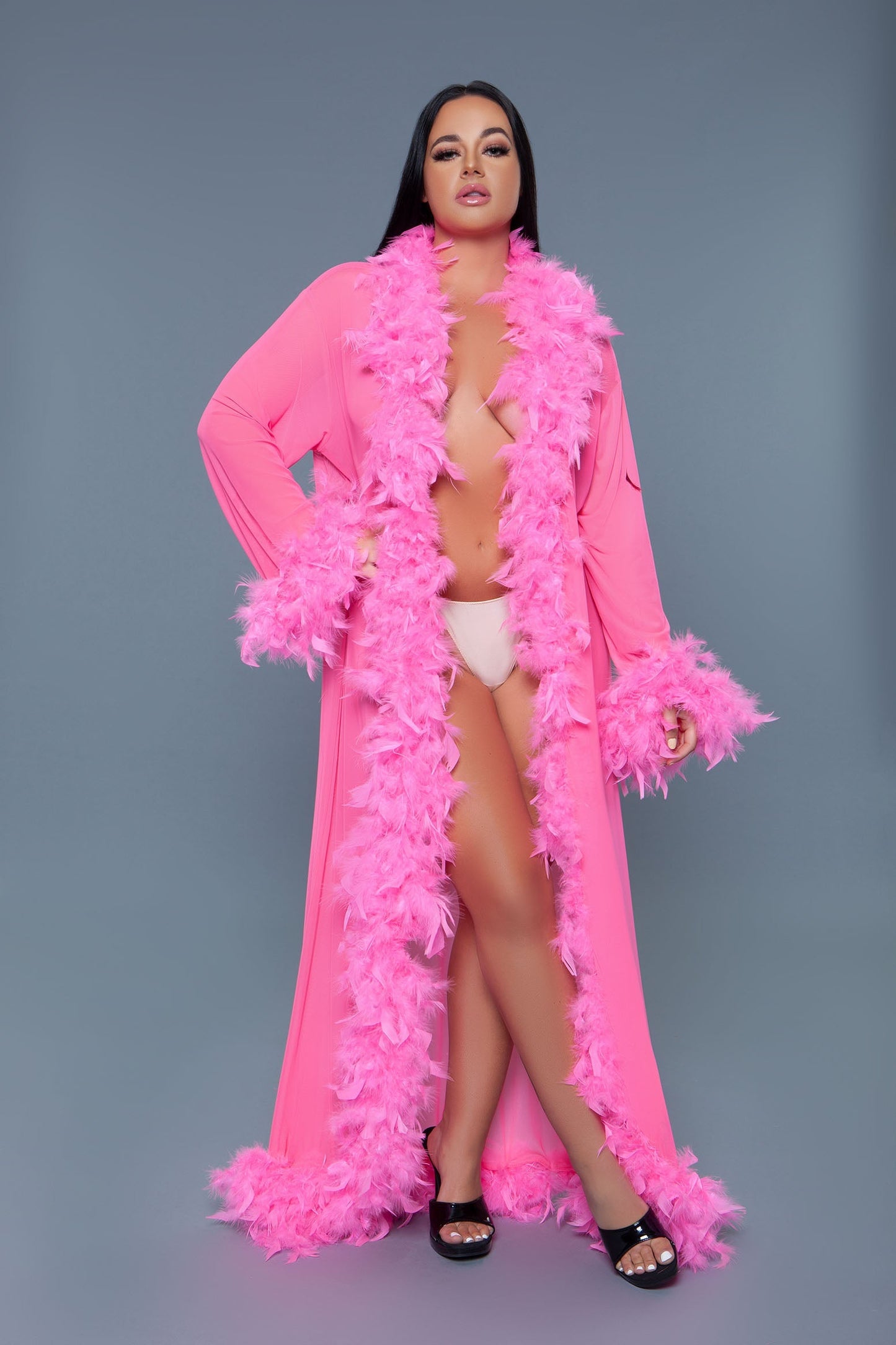 Long Glamour chiffon robe with feather boa trim is a playful yet elegant garment that combines the airy lightness of chiffon with the whimsical allure of a feather boa trim. This robe is designed for those who love to add a touch of glamour and fun to their loungewear. Sheer Feather trim Long sleeves Front tie satin ribbons Thong not included. Be Wicked polybag with Be Wicked hand tag and UPC stickers.